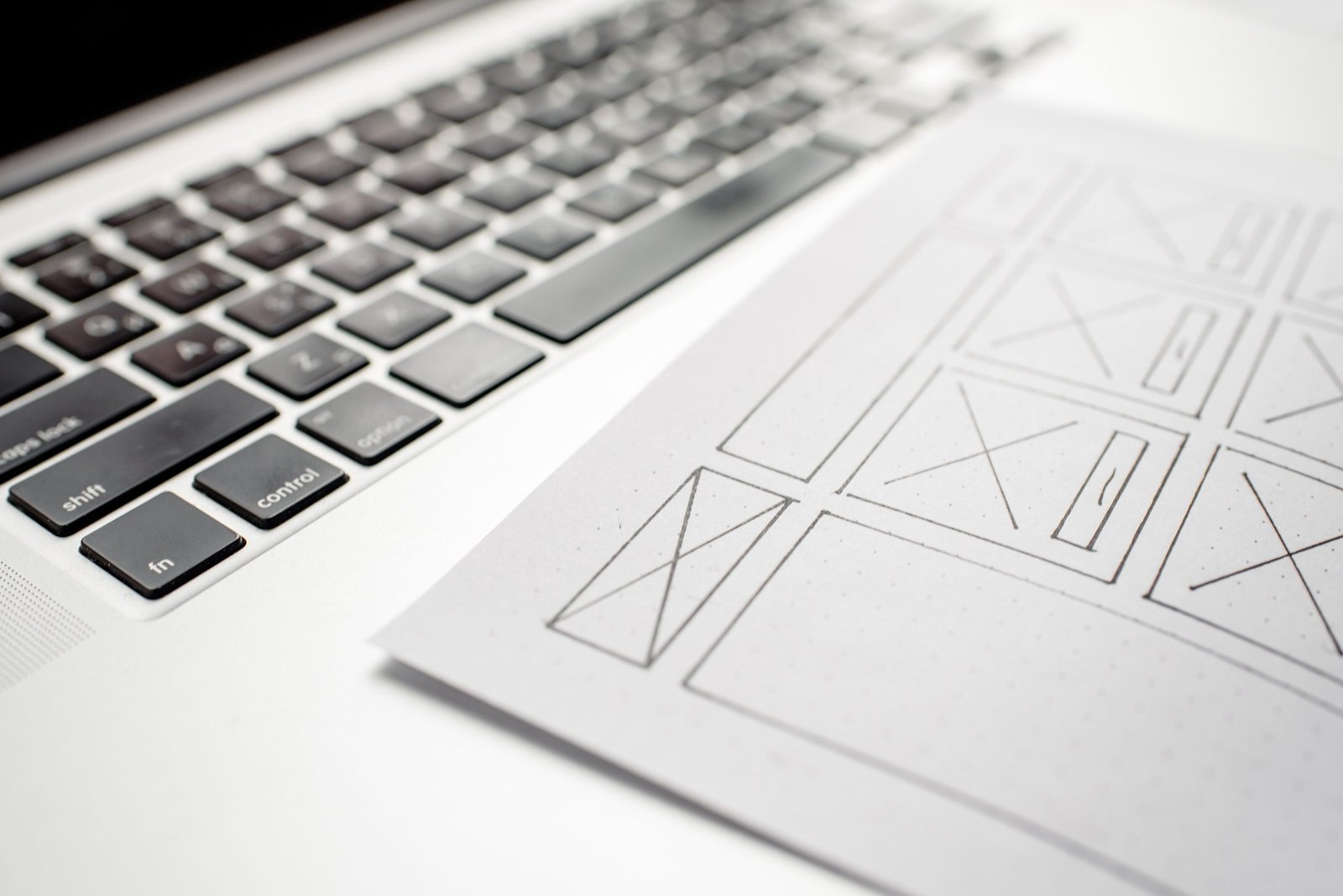 Designer reviewing a website interface on a laptop