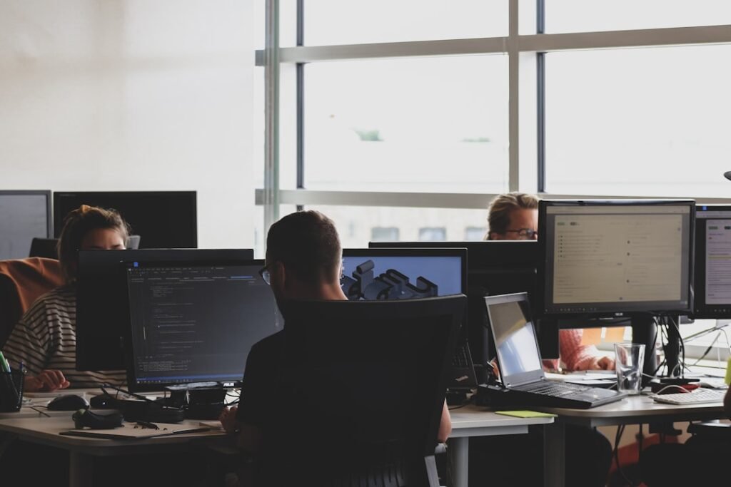 Technology team working together at a computer during an incident response