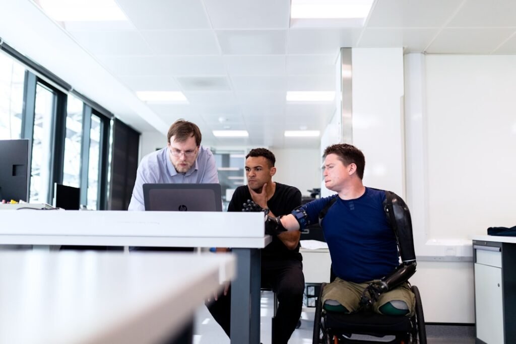 Engineers reviewing an accessible technology design with a prosthetic limb user