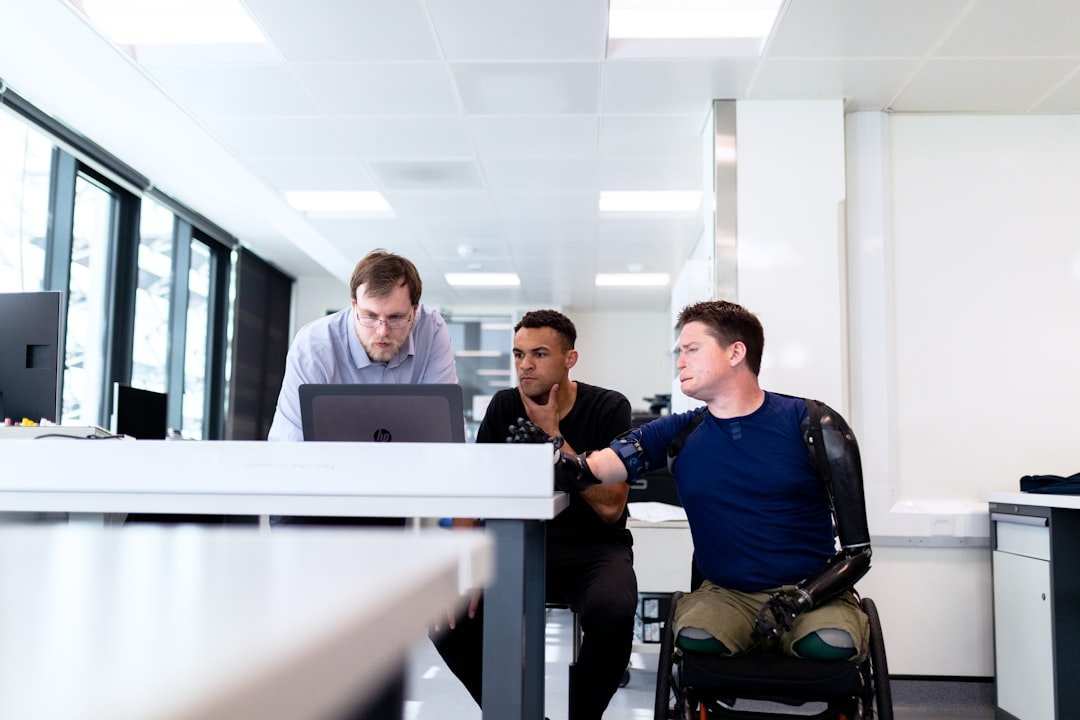 Engineers reviewing an accessible technology design with a prosthetic limb user